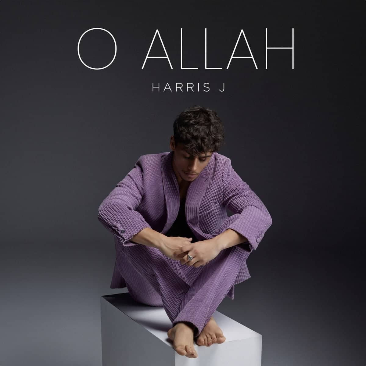 O Allah cover: Harris J in a lilac suit seated on a white plinth
